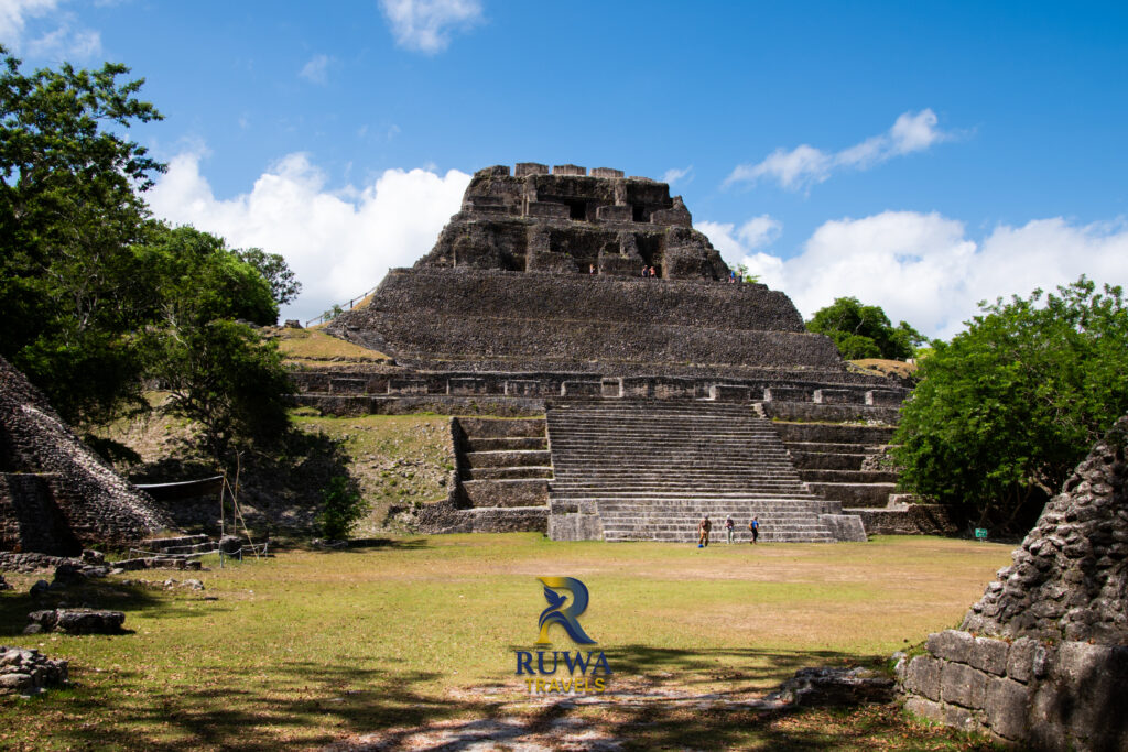 El Castillo pyramid at Xunantunich Maya ruins in Belize, with tourists at the base for scale